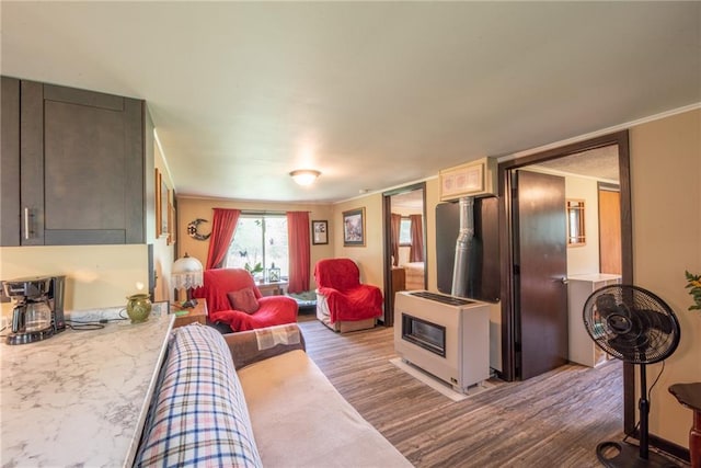 4620W Sweitzer Rd, Winter, WI 54896 - living room with dark wood finished floors, a wood stove, and crown molding