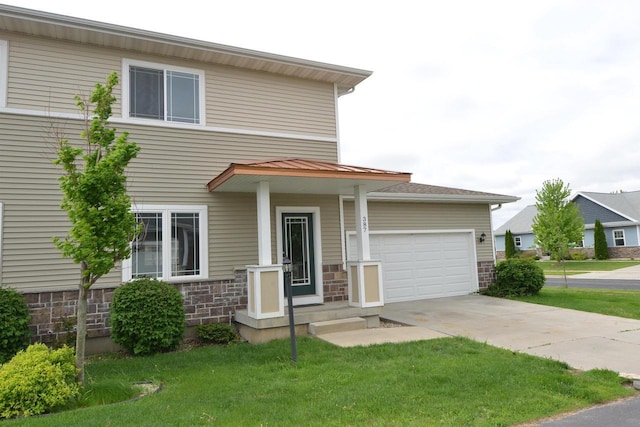 387 Bella Way, Sun Prairie, WI 53590 - view of front facade with concrete driveway, a garage, a front lawn, and stone siding