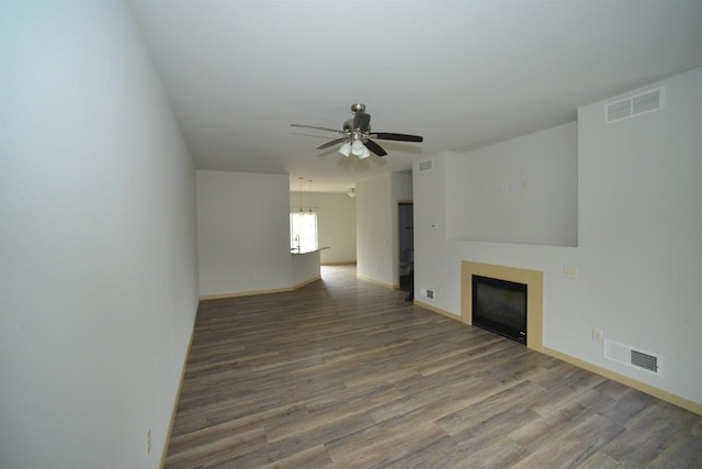387 Bella Way, Sun Prairie, WI 53590 - unfurnished living room with ceiling fan, wood finished floors, a fireplace, and baseboards