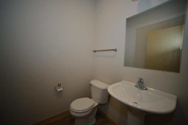 387 Bella Way, Sun Prairie, WI 53590 - bathroom featuring toilet, wood finished floors, a sink, and baseboards