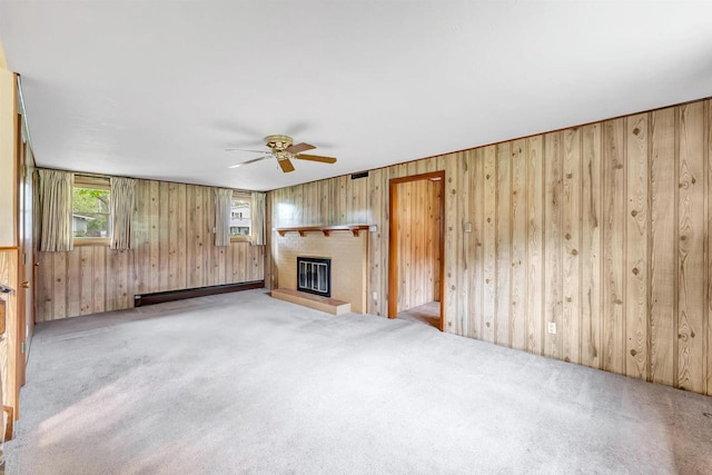 2044 E Vista Cir, De Pere, WI 54115 - unfurnished living room with a ceiling fan, wooden walls, a fireplace, carpet floors, and a baseboard heating unit