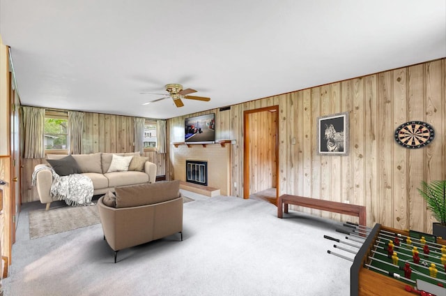 2044 E Vista Cir, De Pere, WI 54115 - carpeted living area with a ceiling fan, wooden walls, and a brick fireplace