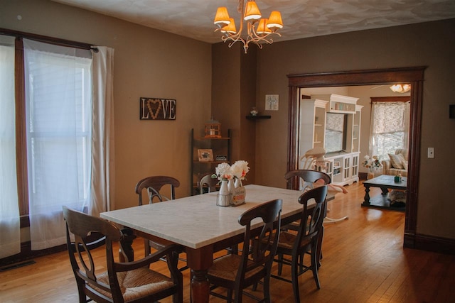 202 Wisconsin St, Mauston, WI 53948 - dining room with light wood finished floors and a chandelier