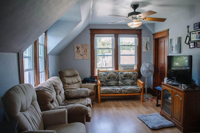 202 Wisconsin St, Mauston, WI 53948 - living area featuring wood finished floors, vaulted ceiling, and a ceiling fan