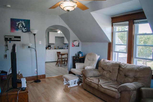 202 Wisconsin St, Mauston, WI 53948 - living area featuring a ceiling fan, light wood-type flooring, arched walkways, and lofted ceiling