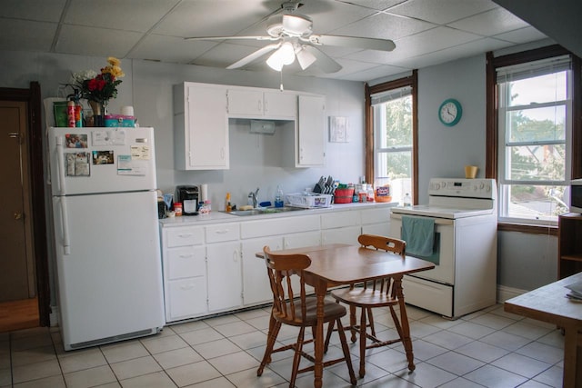 202 Wisconsin St, Mauston, WI 53948 - kitchen with white appliances, a sink, ceiling fan, white cabinetry, and light countertops