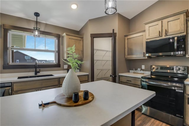 3557 114th St, Chippewa Falls, WI 54729 - kitchen featuring appliances with stainless steel finishes, a sink, light countertops, decorative light fixtures, and vaulted ceiling