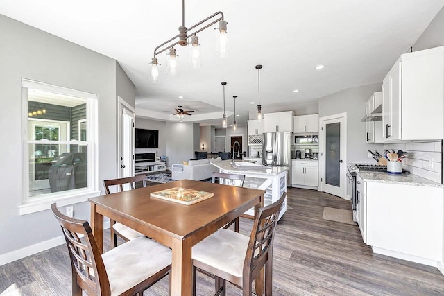 441 Longwood Ln, Wrightstown, WI 54180 - dining space featuring dark wood finished floors, a ceiling fan, baseboards, and recessed lighting
