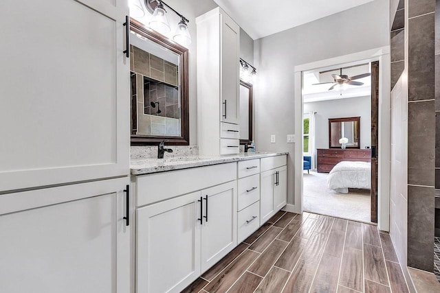 441 Longwood Ln, Wrightstown, WI 54180 - full bathroom with double vanity, ensuite bath, a ceiling fan, and wood finish floors