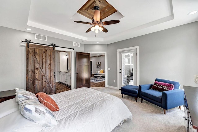441 Longwood Ln, Wrightstown, WI 54180 - bedroom featuring a tray ceiling, recessed lighting, a barn door, light carpet, and baseboards