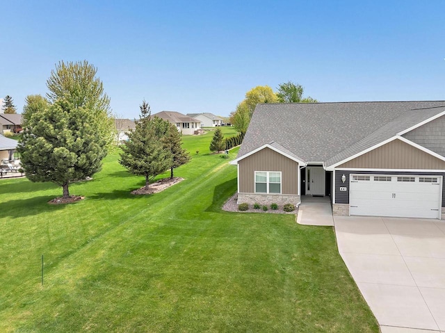 441 Longwood Ln, Wrightstown, WI 54180 - view of front of home featuring a garage, driveway, a shingled roof, and a front lawn