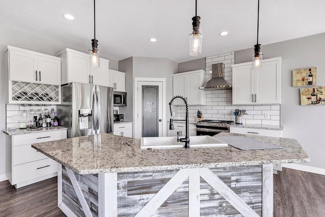 441 Longwood Ln, Wrightstown, WI 54180 - kitchen featuring wall chimney exhaust hood, appliances with stainless steel finishes, backsplash, dark wood-style flooring, and white cabinetry