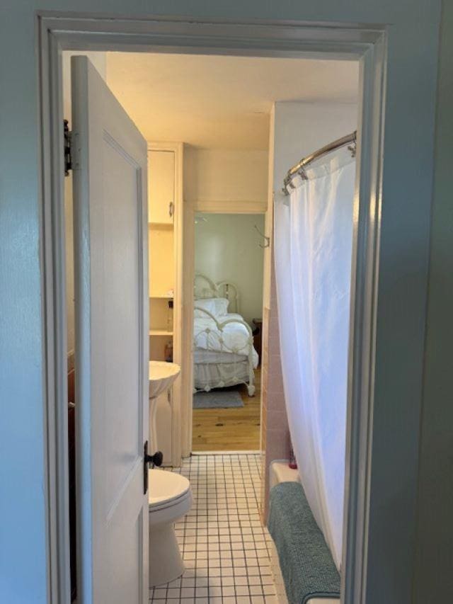 240 6th St S, Bayfield, WI 54814 - bathroom featuring tile patterned floors, toilet, and shower / tub combo