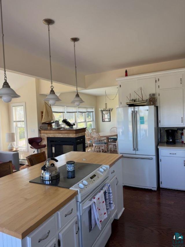 240 6th St S, Bayfield, WI 54814 - kitchen with white appliances, white cabinetry, wood counters, and decorative light fixtures