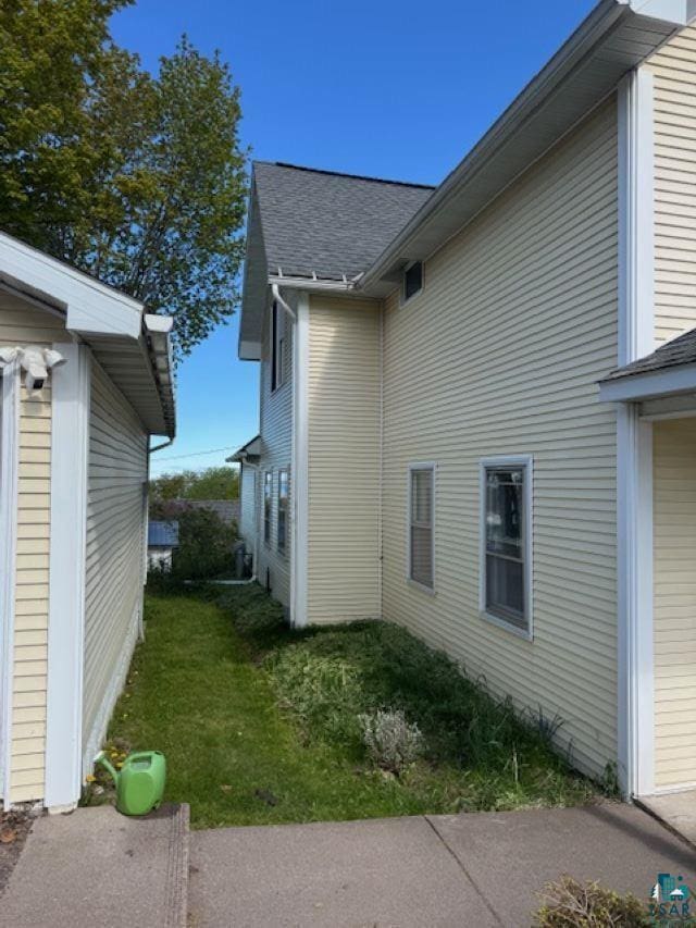 240 6th St S, Bayfield, WI 54814 - view of property exterior with a shingled roof and a lawn