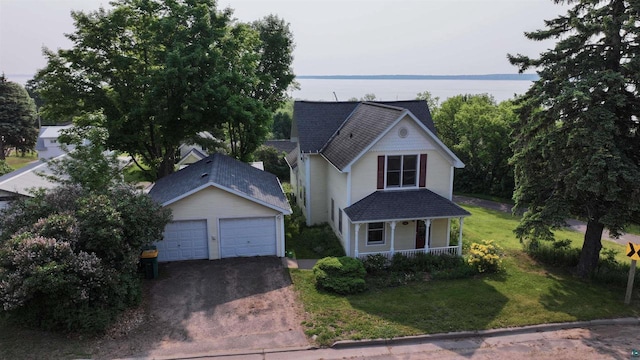 240 6th St S, Bayfield, WI 54814 - victorian house with covered porch, a garage, a front yard, and a shingled roof