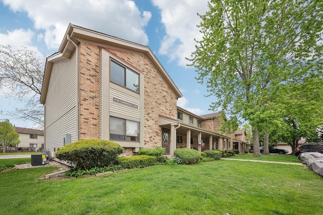 5748 Cambridge Ln Unit 3, Mount Pleasant, WI 53406 - exterior space with brick siding, a front yard, and central air condition unit