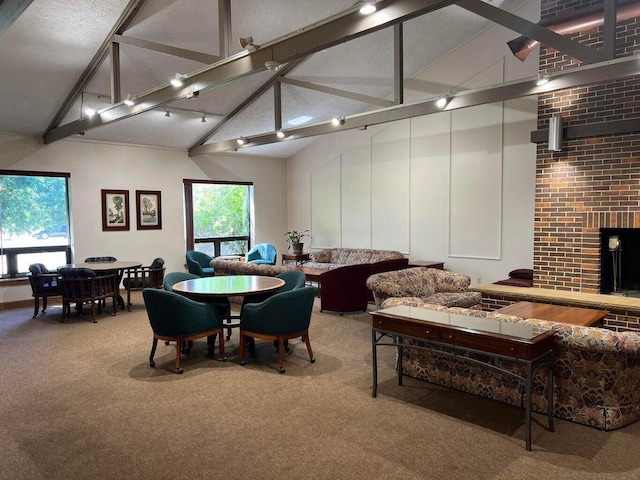 5748 Cambridge Ln Unit 3, Mount Pleasant, WI 53406 - carpeted dining room featuring high vaulted ceiling, a fireplace, plenty of natural light, and beamed ceiling
