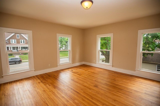 217 E Division St, Dodgeville, WI 53533 - unfurnished room featuring light wood finished floors, plenty of natural light, and baseboards