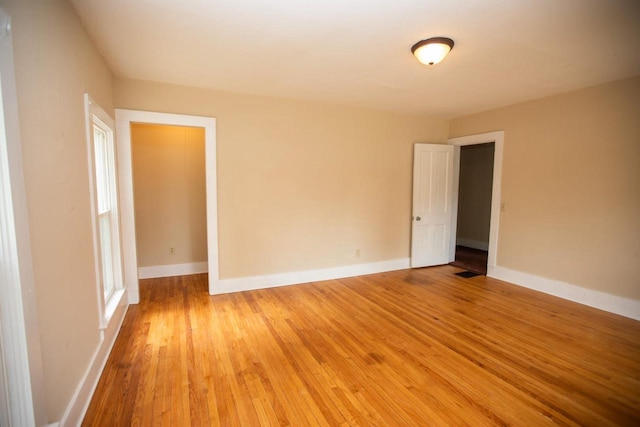 217 E Division St, Dodgeville, WI 53533 - unfurnished room with light wood-style flooring and baseboards