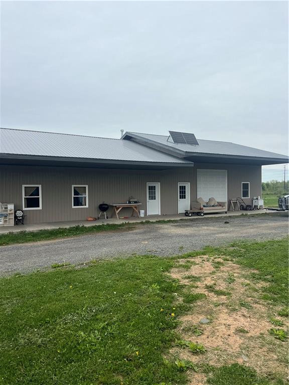 14518 State Highway 73, Lublin, WI 54447 - back of house with metal roof, roof mounted solar panels, and an attached garage