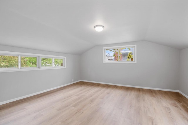 745 Carver Ln, Menasha, WI 54952 - bonus room featuring light wood-style floors, vaulted ceiling, and baseboards