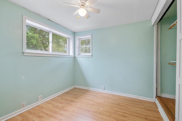 745 Carver Ln, Menasha, WI 54952 - unfurnished bedroom with light wood finished floors, baseboards, and a closet