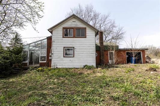 2608 County Road T, Sun Prairie, WI 53590 - rear view of house with a sunroom