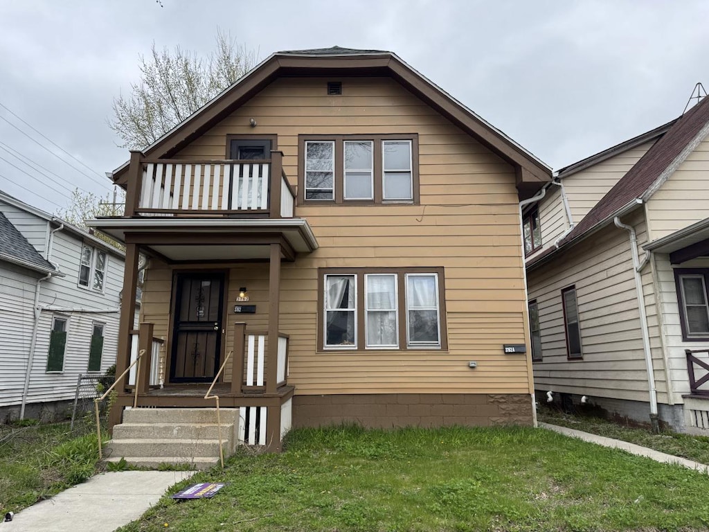 3762 N 5th St Unit 3762A, Milwaukee, WI 53212 - view of front of home with a balcony and a front lawn