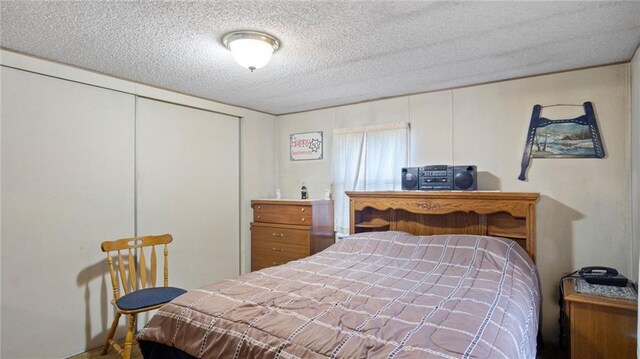 207 State Rd 25, Wheeler, WI 54772 - bedroom with a textured ceiling and a closet