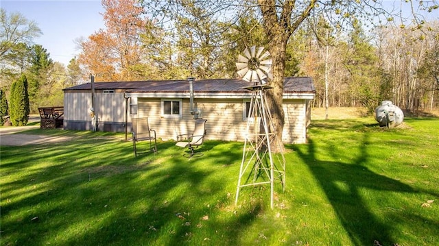207 State Rd 25, Wheeler, WI 54772 - rear view of house with a lawn and metal roof