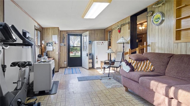 207 State Rd 25, Wheeler, WI 54772 - living room featuring wood walls and brick patterned floors