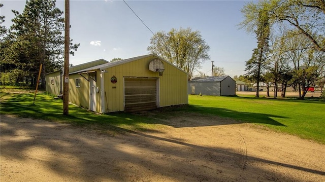 207 State Rd 25, Wheeler, WI 54772 - detached garage featuring dirt driveway