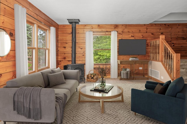 11934 187th Ave, Bristol, WI 53104 - living room with a wood stove, wood walls, and stairway