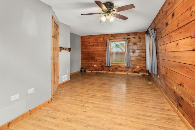 11934 187th Ave, Bristol, WI 53104 - spare room featuring wooden walls, light wood-style floors, ceiling fan, and baseboards