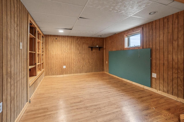 11934 187th Ave, Bristol, WI 53104 - basement with wood walls, wood finished floors, a drop ceiling, and baseboards
