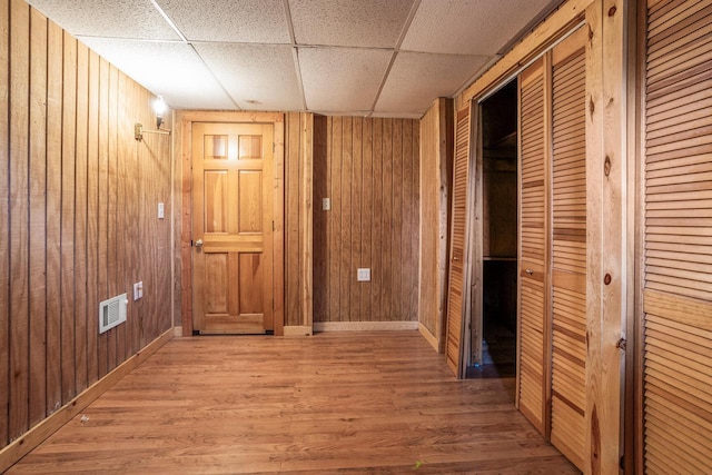 11934 187th Ave, Bristol, WI 53104 - hallway featuring wood finished floors, wood walls, baseboards, and a paneled ceiling
