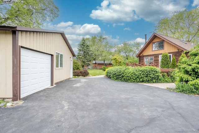11934 187th Ave, Bristol, WI 53104 - view of patio / terrace featuring a garage, driveway, and an outdoor structure