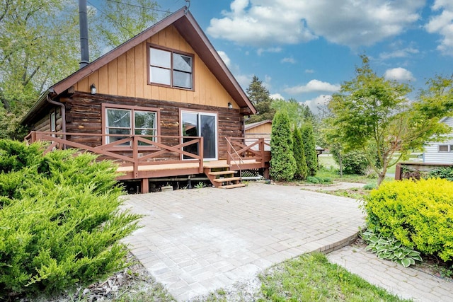 11934 187th Ave, Bristol, WI 53104 - back of house featuring log exterior, a deck, and a patio