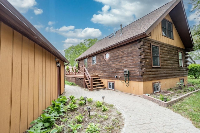 11934 187th Ave, Bristol, WI 53104 - view of home's exterior with log exterior, roof with shingles, a wooden deck, and stairs