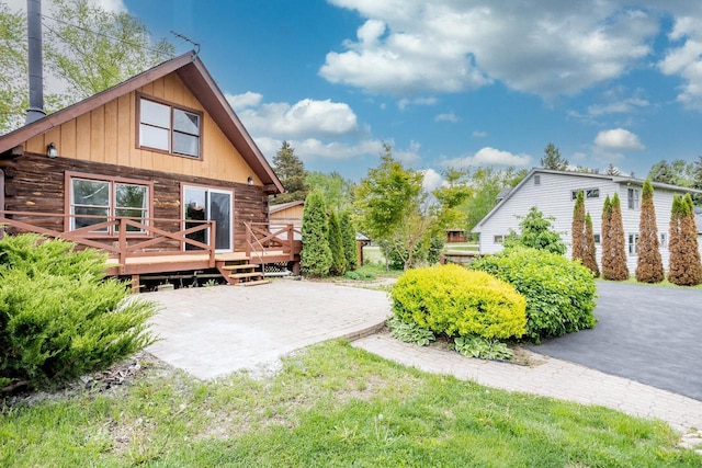 11934 187th Ave, Bristol, WI 53104 - rear view of property featuring a wooden deck, log exterior, and a patio area