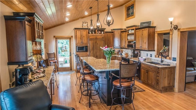 S523 Cole Rd, Mondovi, WI 54755 - kitchen with built in microwave, brown cabinets, a sink, wooden ceiling, and a kitchen breakfast bar