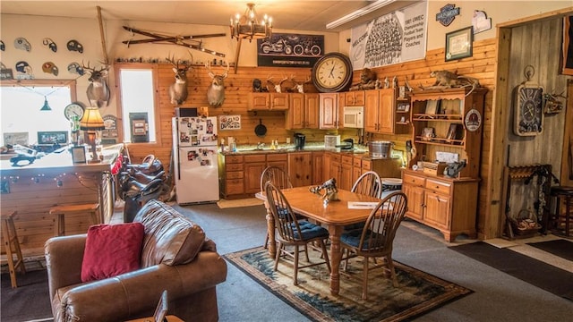 S523 Cole Rd, Mondovi, WI 54755 - dining room with wood walls, dark carpet, and a chandelier