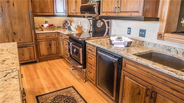 S523 Cole Rd, Mondovi, WI 54755 - kitchen featuring light wood-type flooring, brown cabinetry, light stone counters, and dishwasher