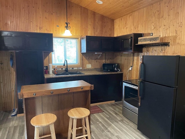 W9001 US Highway 8, Pembine, WI 54156 - kitchen with black appliances, a sink, wooden walls, light wood-style floors, and wood ceiling