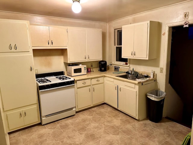 533 High Ave, Oshkosh, WI 54901 - kitchen featuring white appliances, light countertops, a sink, and white cabinetry
