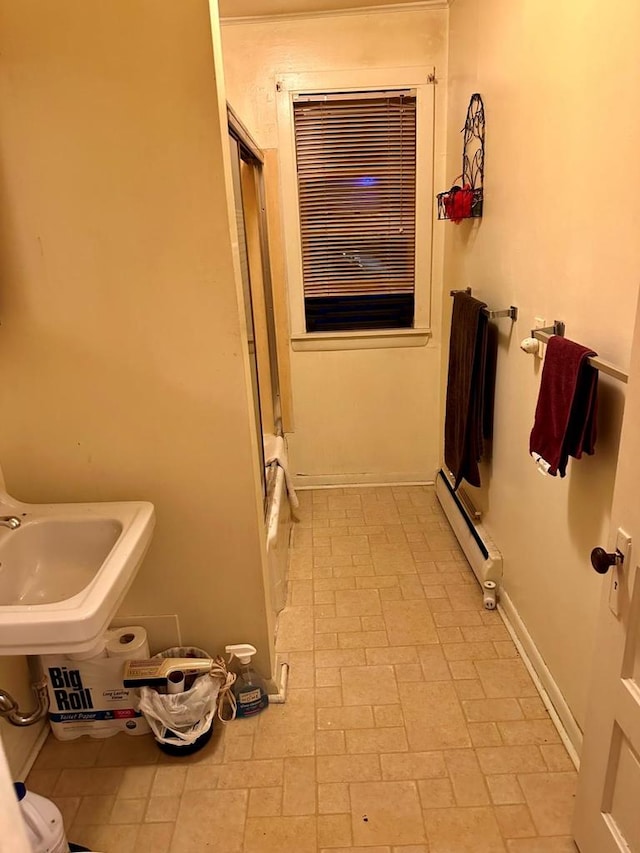 533 High Ave, Oshkosh, WI 54901 - full bath featuring a baseboard heating unit, a sink, a shower with door, and baseboards