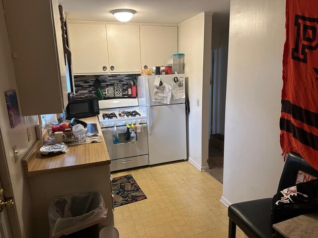 533 High Ave, Oshkosh, WI 54901 - kitchen with white appliances, tasteful backsplash, white cabinetry, and baseboards