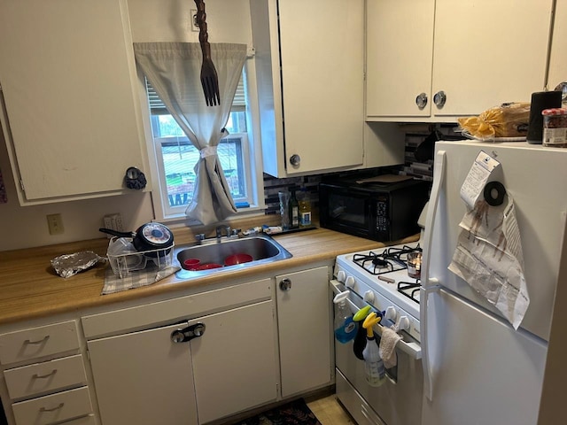 533 High Ave, Oshkosh, WI 54901 - kitchen with white appliances, a sink, light countertops, and white cabinetry