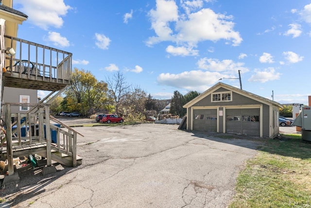 533 High Ave, Oshkosh, WI 54901 - view of property exterior featuring a garage, an outbuilding, and a deck